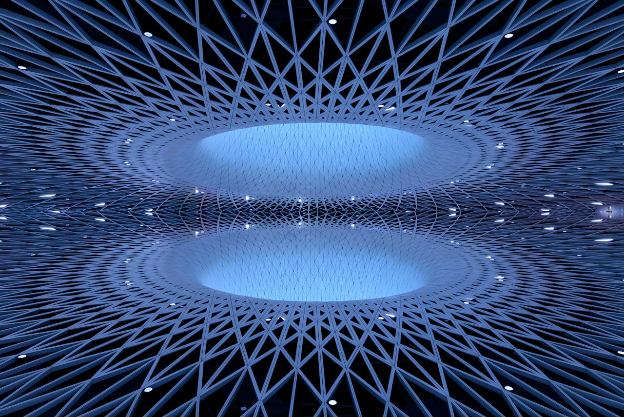 Explore a stunning modern dome architecture with intricate patterns and futuristic symmetry in a cool blue tone.